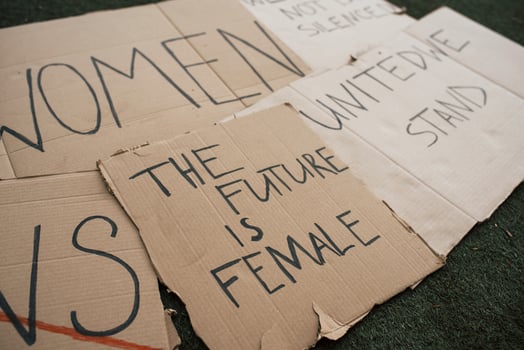 Handmade signs. Group of banners with different feminist quotes lying on the ground photo