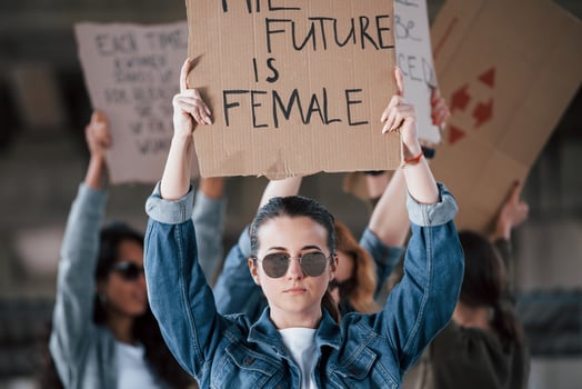Reflection of ground in sunglasses. Group of feminist women have protest for their rights outdoors photo