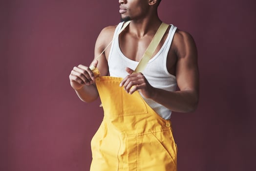 In his new house. Young african american worker in the yellow uniform have some job photo