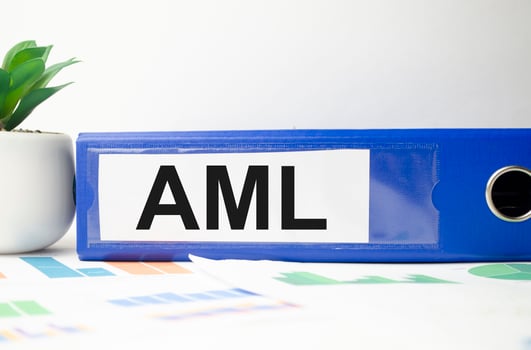 blue file folder with words take AML Anti-Money Laundering . Business concept photo