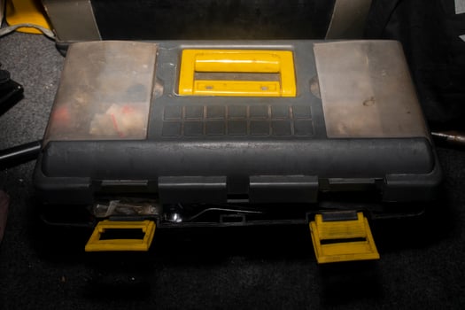 closed toolbox with yellow handle and lock photo