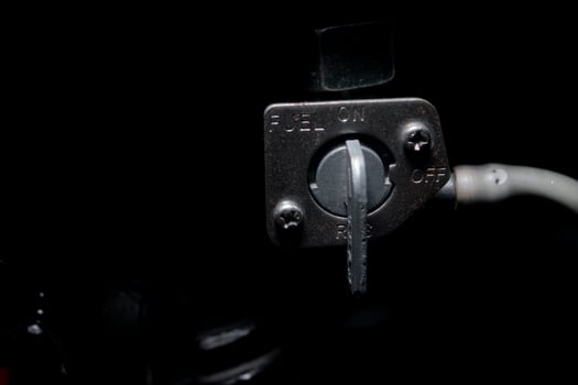 fuel tap of motorcycle. automotive parts on dark background photo