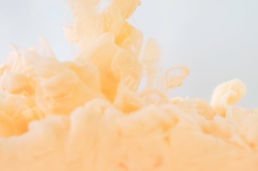 Blurred and focus orange poster color dissolving in water for abstract and backgorund concept. photo