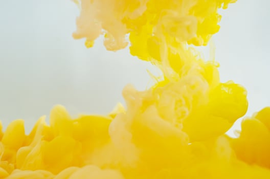Blurred and focus yellow poster color dissolving in water for abstract and backgorund concept. photo