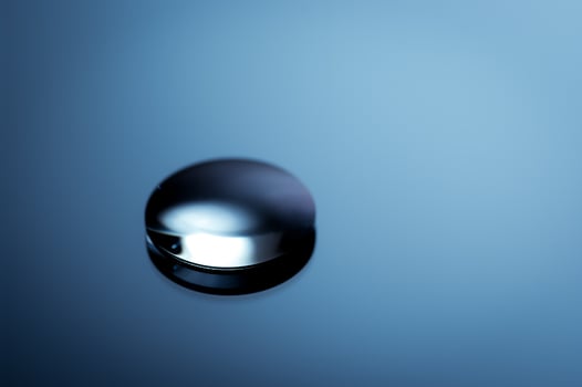 Abstract round object in blue monochrome. Minimalist still life image. photo