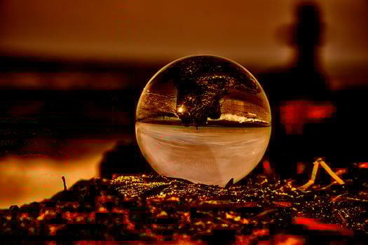 Abstract representation of a glass ball on a groyne on the Baltic Sea. photo