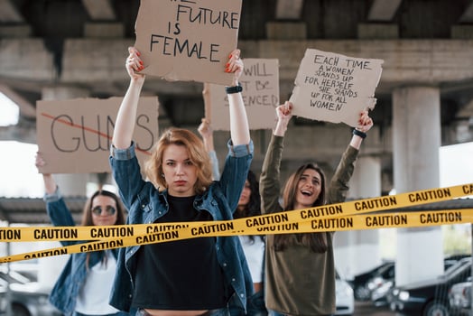 Behind the borderline. Group of feminist women have protest for their rights outdoors photo
