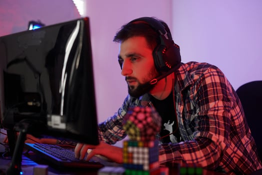 Portrait of young bearded pro gamer playing in online video game photo