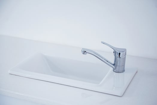 Close up view of domestic metal faucet. Clean surface photo