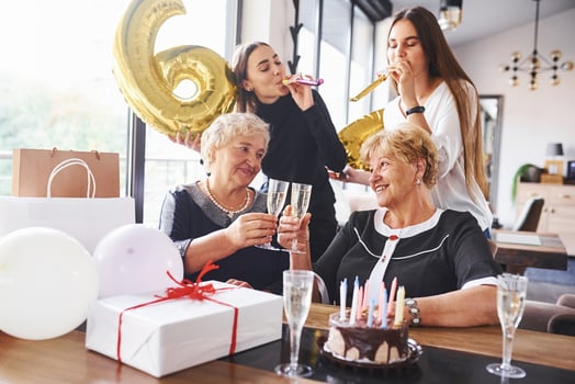 Balloons with number 60. Senior woman with family and friends celebrating a birthday indoors photo