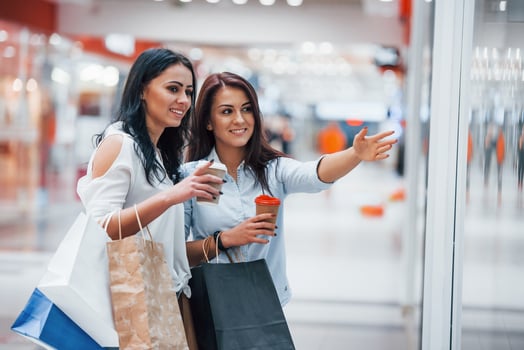 Two young women have a shopping day together in the supermarket photo