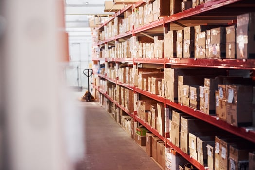 Storage room with pallet truck and many of objects at daytime photo