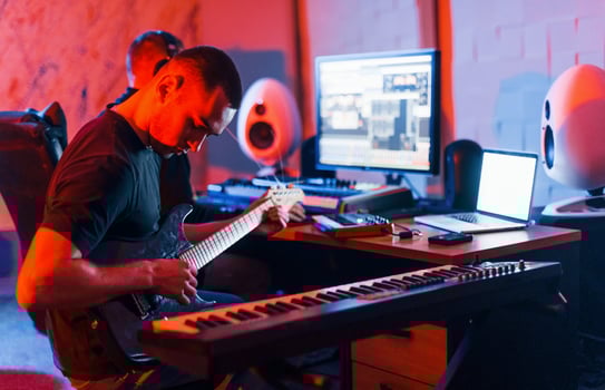 Guy have a job with project and mixing music indoors in the studio photo