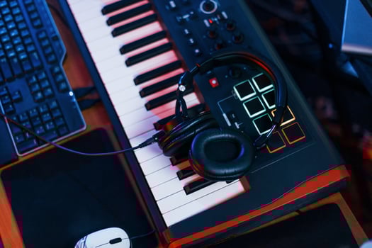 Close up view of headphones that lying down on the keyboard in the studio photo