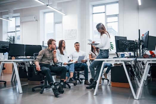 People talking and working together in the modern office near computers photo