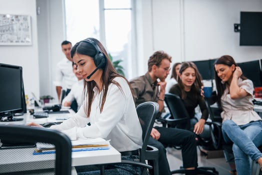 Inside of call center. Young business people working together in the modern office photo