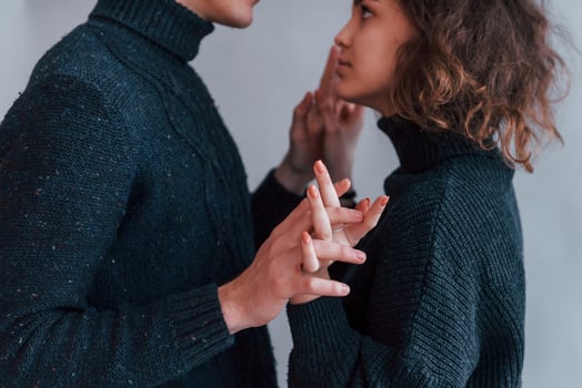 Cute young couple embracing each other indoors in the studio photo