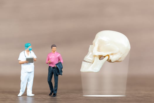 Miniature people patients are discussed  by an orthopedic physician photo