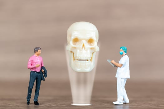 Miniature people patients are discussed  by an orthopedic physician photo