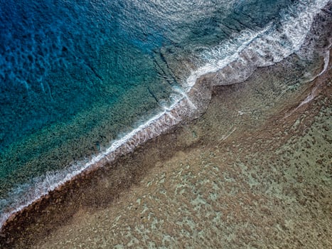 aerial view of waves on reef of polynesia Cook islands photo