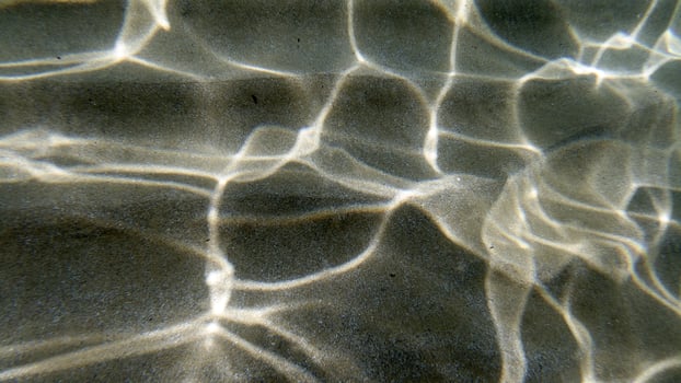 sand bottom underwater swimming in turquoise lagoon photo