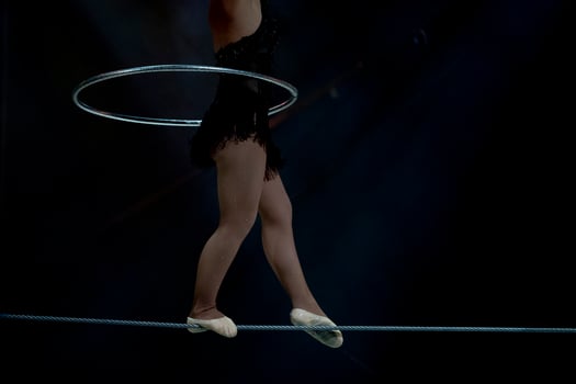 circus equilibrist steel wire artist isolated on black photo