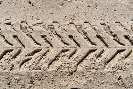 offroad tire track on sandy beach photo