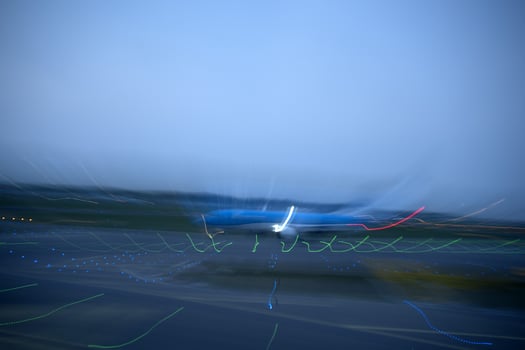airport lights in motion while airplane taking off at night photo