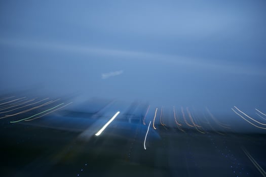 airport lights in motion while airplane taking off at night photo