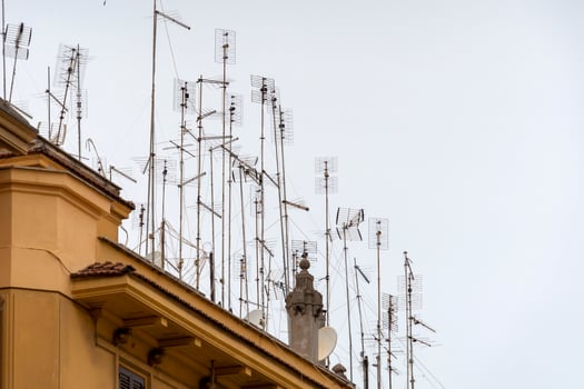 Many television antennas in rome building photo