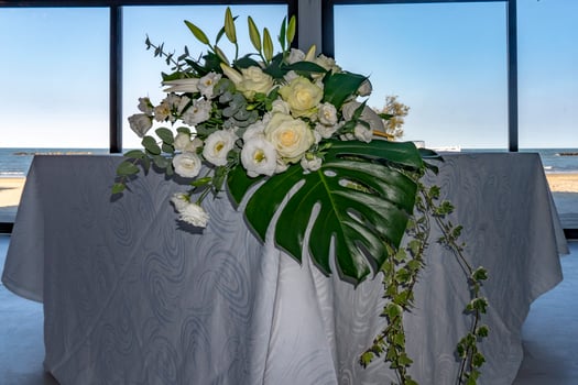 white rose bride bouquet close up detail on wedding table photo