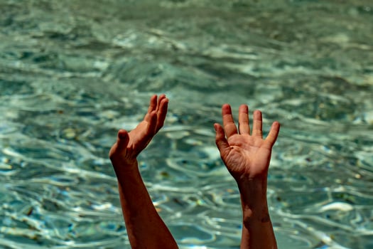 hands of black Migrant detail on boat asking for help from the sea background photo