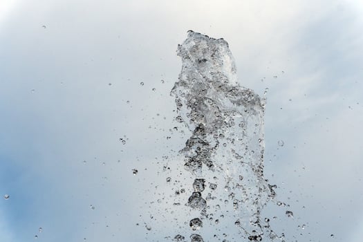 water spurt detail isolated on sky photo