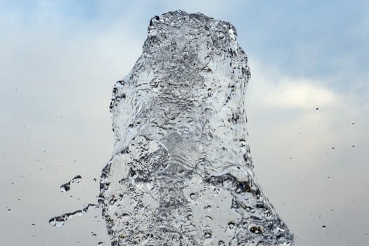 water spurt detail isolated on sky photo