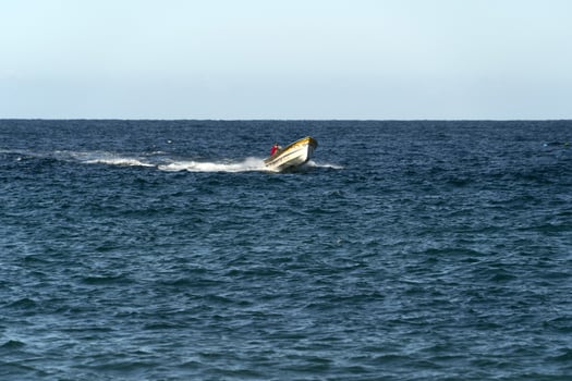 fisherman boat going back to the beach in baja california beach mexico photo