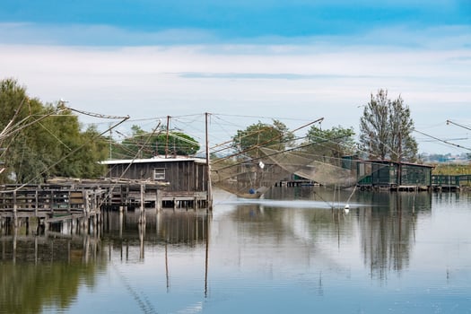 fishing trebuchets with nets on the water photo