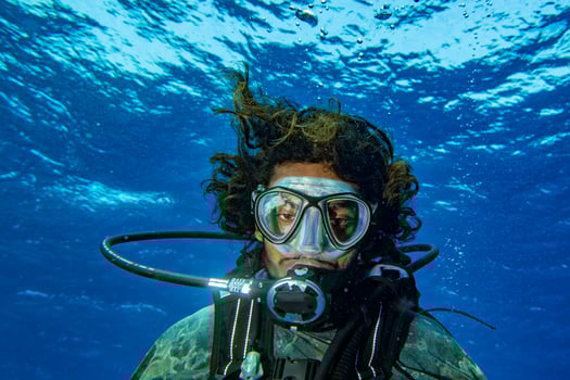 Scuba diver smiling underwater selfie portrait in the ocean photo