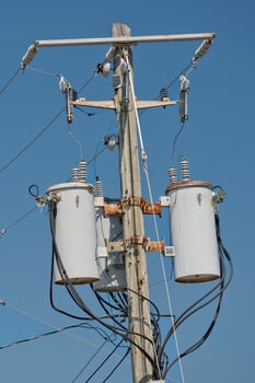 Electric cables tangle on wood post photo