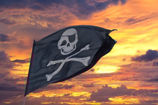 waving pirate flag jolly roger on sky background photo