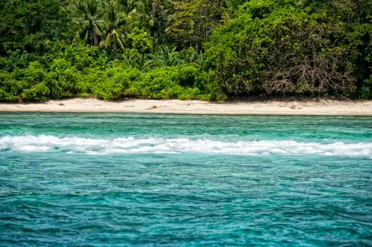 Siladen turquoise tropical paradise island waves on the reef photo