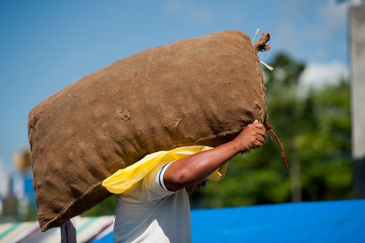 Asian male hands holding sack in a harbor photo