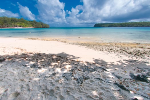White sand beach on turquoise tropical paradise lagoon photo