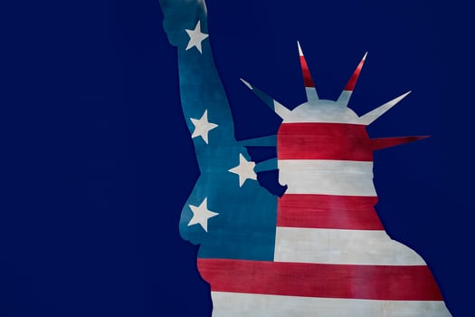 Statue of liberty in New York silhouette on usa star and stripes flag photo