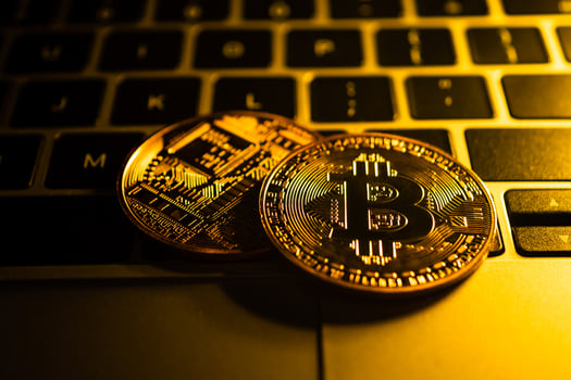 Golden coins with bitcoin symbol on computer. photo