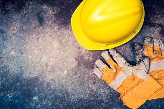 Safety helmet and gloves on a grunge background. photo