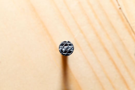 wooden background and nail, close up photo