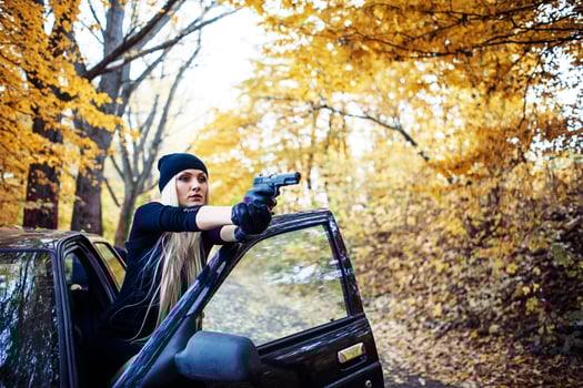 Sexy blonde girl with weapon photo