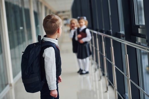 School kids in uniform together in corridor. Conception of education photo