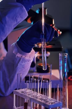 Scientist in white protective uniform works with coronavirus and blood tubes in laboratory photo
