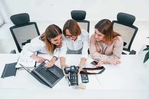Front view of group of business people in formal clothes working indoors in the office photo